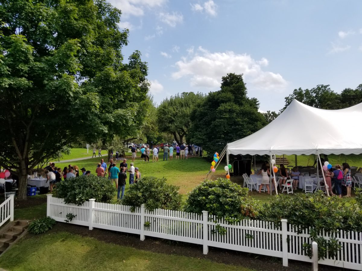Events at Tarrywile tent on back lawn with people playing lawn games